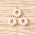 Detailed view of pink enamel donut charms with gold dots for DIY jewelry making - 5 Pieces / Pink Donut