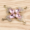 Detailed view of pink pear-shaped gemstone pendants with gold plating and cubic zirconia - Pink