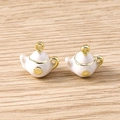 Macro view of white enamel teapot charms with gold alloy frames for jewelry making - 5 Pieces / White Teapot