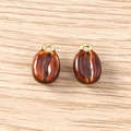 Detailed macro view of two coffee bean charms with gradient brown enamel and gold rings - 5 Pieces / Coffee Bean