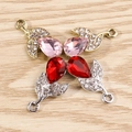 Close-up of leaf-shaped jewelry pendants with water-drop crystals and white rhinestones - Multicolor
