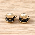 Detailed macro view of miniature black enamel and gold plated teacup charm pendants - 5 Pieces / Black Coffee Cup