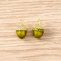 Detailed macro view of olive green enamel acorn charms with golden metal textured caps - 5 Pieces / Green Acorn