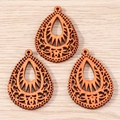 Detailed laser-cut bohemian style wooden water drop pendants on a light wood background - 10 Pieces Pack / Hollow Teardrop
