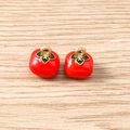 Close-up of 3D red persimmon pendants with enamel finish and golden hanging loops - 5 Pieces / Tomato
