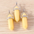 Macro detail of three light yellow hexagonal bullet stone pendants with silver metal clasps - 5 Pieces / Yellow