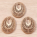 Macro shot of three laser-cut oval wooden jewelry pendants with geometric hollow patterns - 10 Pieces Pack / Hollow Ring