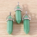 Detail view of three green hexagonal crystal bullet pendants with silver metal clasps - 5 Pieces / Emerald Green