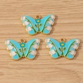 Three sky blue enamel butterfly charms with gold trim and lily of the valley floral patterns - 10 Pieces Pack / Blue Butterfly