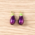 Detailed macro view of two purple eggplant resin charms with golden metal loops - 5 Pieces / Eggplant
