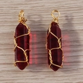 Detail of two red crystal hexagonal pendants with golden wire wrap on wood background - Dark Red