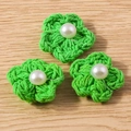 Close-up of three green crochet flower pendants with white pearls for DIY jewelry making - Flower Shape / Green Flower