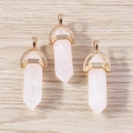 Macro detail of three rose quartz hexagonal bullet pendants with rose gold metal caps - 5 Pieces / Gold Pink