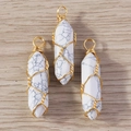 Macro detail of white howlite hexagonal stone pendants with gold wire wrapping - White