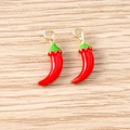 Macro detail of red chili pendants with golden rings and green stem on wood - 5 Pieces / Chili