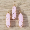 Detailed view of pink hexagonal crystal pendants with gold wire wrapping for jewelry making - Ice Pink