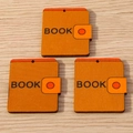 Three book-shaped wooden pendants with BOOK text for DIY jewelry making and craft projects - Notebook / 10 Pieces Pack