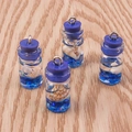 Macro detail of four glass drift bottle pendants with tiny shells and blue sequins inside - 10 Pieces Pack / Dark Blue