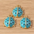 Three light blue ladybug charms with golden alloy base for DIY jewelry making - 10 Pieces Pack / Blue Ladybug