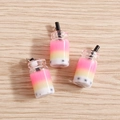 Three gradient bubble tea bottle pendants with black straws on a light wood background - 10 Pieces Pack / Rose Red