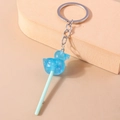 Blue glittery resin duck lollipop keychain with light cyan stick and silver metal ring - Blue Duck Lollipop