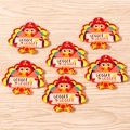 Macro shot of colorful acrylic Thanksgiving turkey pendants with Gobble Gobble text - Gobble Letter Turkey