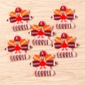 Detail of 6 acrylic Thanksgiving turkey and football charms with GOBBLE text on wood background - Football Turkey