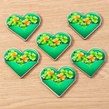 Detail view of heart-shaped St. Patrick's Day pendants with green clover and orange designs - 10 Pieces Pack / Love Heart Envelope