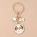 Details des mintgrünen Emaille-Hundeanhängers mit Goldkette und Cupcake-Anhänger - Grüner Teddy