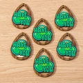 Macro view of teardrop shamrock wood pendants with green print for jewelry making - 10 Pieces Pack / Letter Shamrock Teardrop