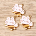 Cute alloy bee bunny charms with gold metal edges for DIY jewelry making on wood background - Bee Rabbit Style