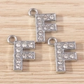 Detailed close-up of rhinestone letter F charms in silver alloy for DIY jewelry - Letter F