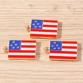 Detailed close-up of three USA flag star pendants with gold plating for DIY jewelry - Medium Flag / 10 Pieces Pack / Red/White/Blue
