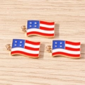 Detail view of three American flag charms in gold-tone alloy for DIY creative keychains - Small Flag / 10 Pieces Pack / Red/White/Blue