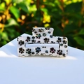Pearlescent white hair claw clip with black paw prints on minimalist display block - Black Paw Prints (Medium Rectangle)