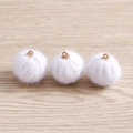 Three white plush pompom pendants with gold metal rings on a light wood surface - 10 Pieces/Pack / White