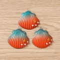 Macro detail of three gradient shell pendants with golden stars and white pearls on wood - 5 Pieces / Orange Red