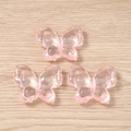 Close-up of translucent pink acrylic butterfly pendants for DIY jewelry and accessories - 5 Pieces / Pink
