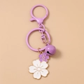 Detailed macro view of purple cherry blossom keychain with bell and gold enamel outlines - Big Purple Bell Flower