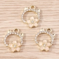 Detailed macro of golden cat-shaped cherry blossom pendants with white rhinestones - 10 Pieces Pack / Nude