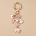Llavero serie océano dorado con pulpo de esmalte rosa, caballito de mar y dije de perla - Concha Rosa