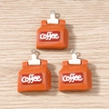 Detailed macro view of coffee bag resin pendants with silver rings on wood surface - 10 Pieces Pack / Coffee Powder Bag