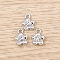 Macro shot of silver flower charms with clear rhinestones and top loops for DIY jewelry - Silver Rhinestone Flower