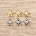 Detailed view of star-shaped jewelry charms with rhinestones and faux pearls on wood - Mixed Color Artificial Pearl Star / 5 Pieces