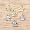 DIY flower charm pendants with rhinestones in gold and silver finish on wooden background - Mixed Rhinestone Flower