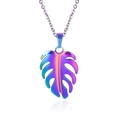 Macro shot of 18k plated stainless steel monstera leaf necklace with colorful gradient finish - Necklace Set / Rainbow