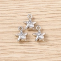 Macro shot of three silver starfish pendants with rhinestones on a wooden background - Silver Shell Star / 5 Pieces