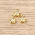 Detailed macro view of three golden star pendants with sparkling rhinestones for DIY jewelry - Gold Shell Star / 5 Pieces