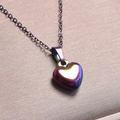 Macro shot of an iridescent heart pendant necklace on premium silk background - Pendant Necklace / Rainbow