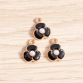 Detail of three black enamel flower charms with pearls and rose gold plating for DIY jewelry - Black